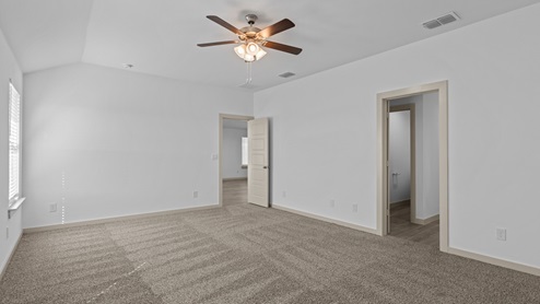 Spacious primary bedroom with attached primary bathroom