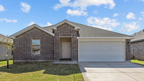 Single story home with brick, covered patio with 2 car garage