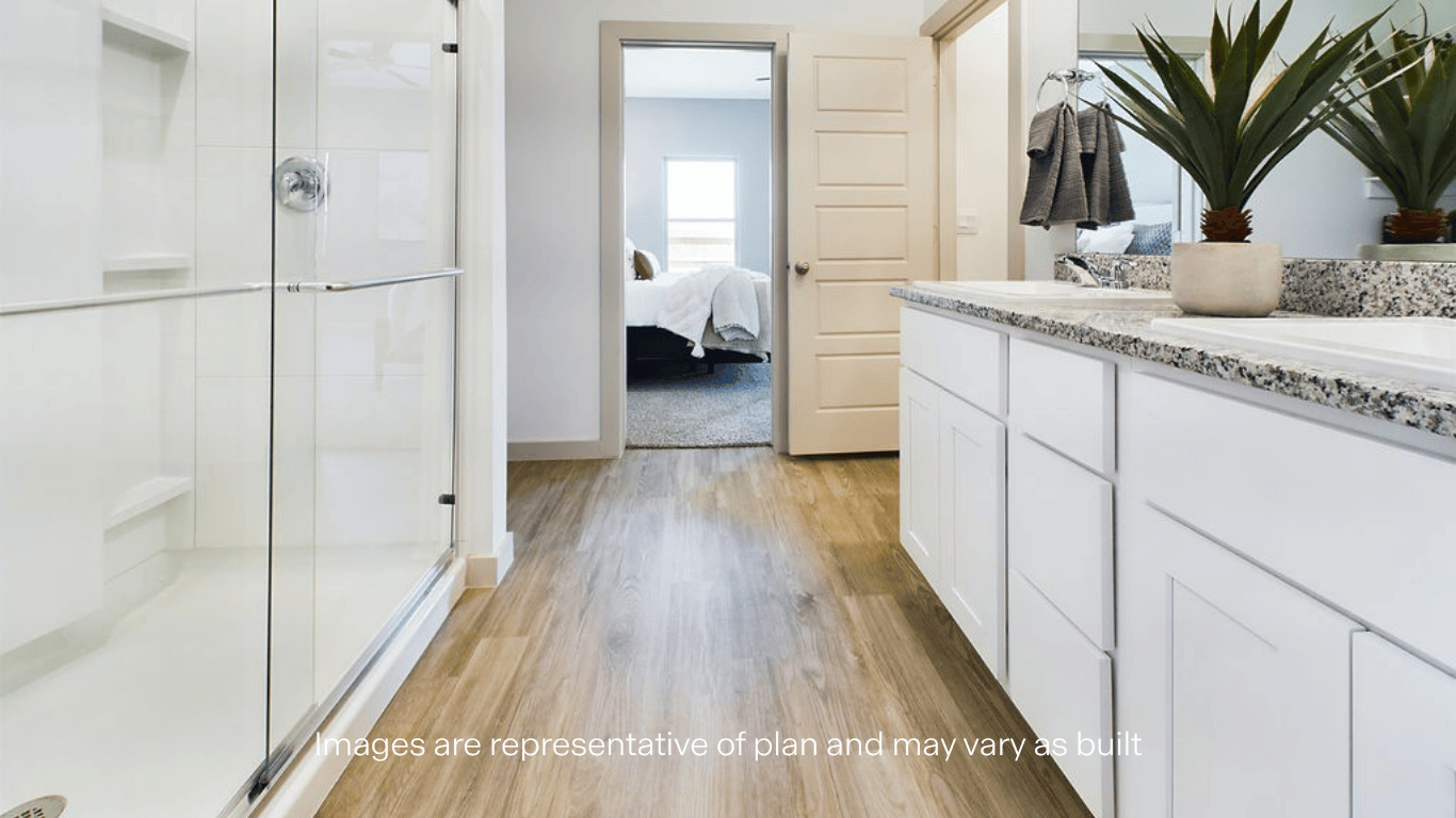Private attached primary bathroom with built in vanity and luxurious shower