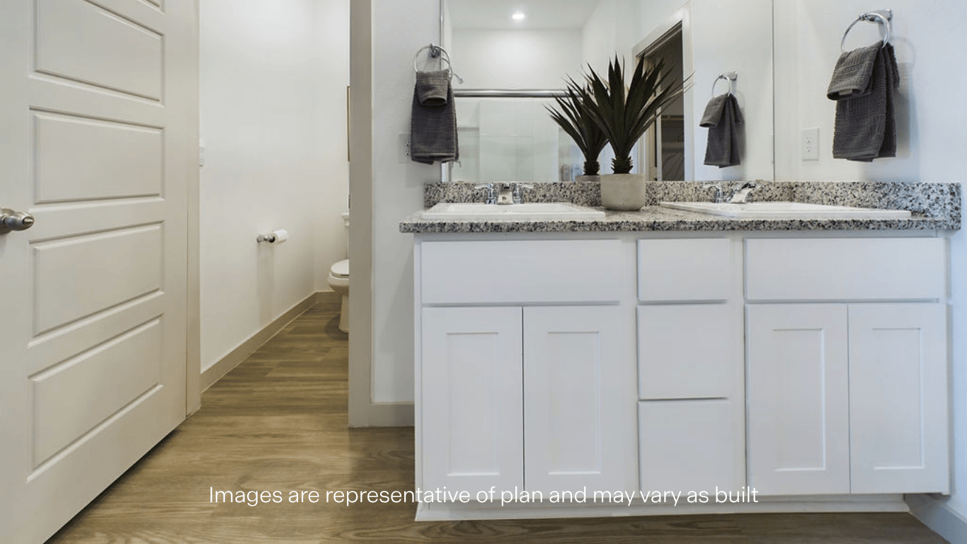 Private attached primary bathroom with built in vanity and luxurious shower
