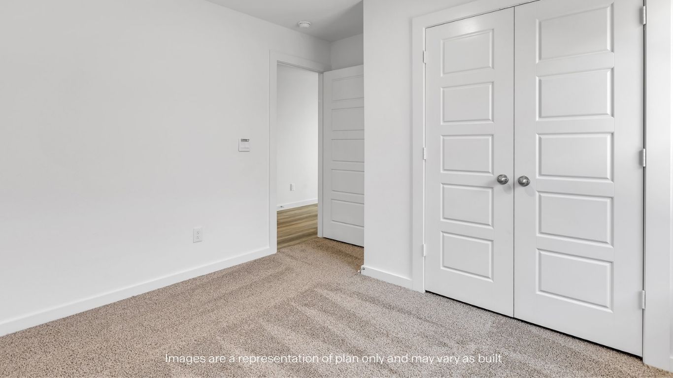 Guest bedroom 1 with plush carpet floors and spacious closet