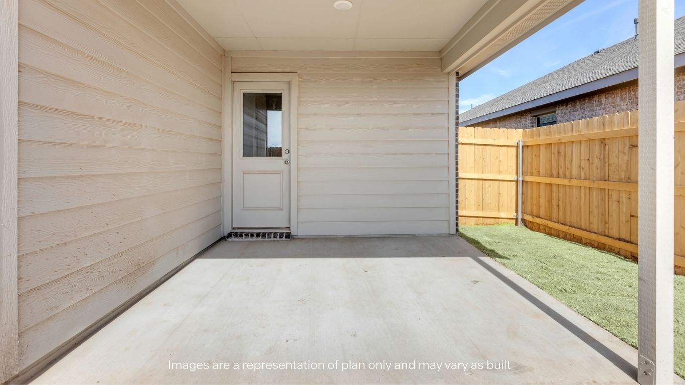 Covered back patio area overlooking spacious backyard
