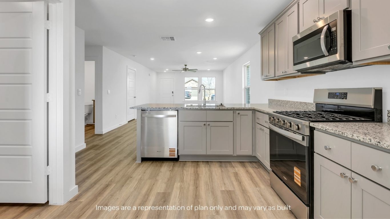 Open concept kitchen with stainless steel appliances, shaker style cabinets, and elevated finishes