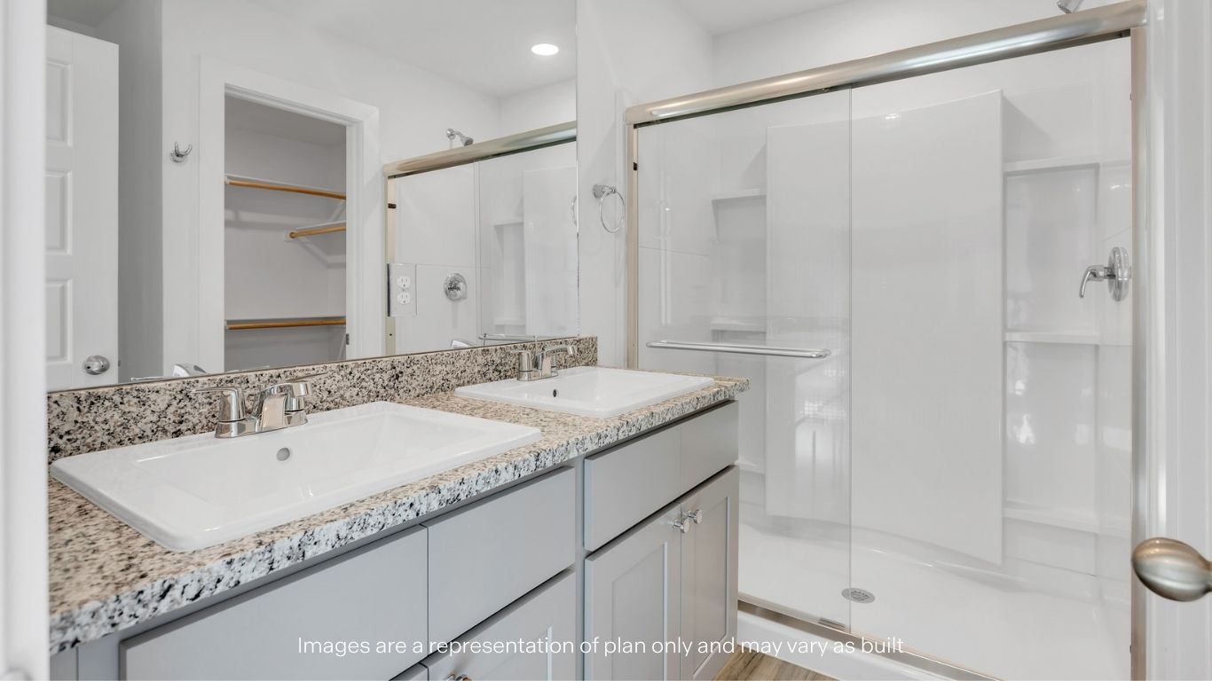 Private attached primary bathroom with built in vanity and luxurious shower