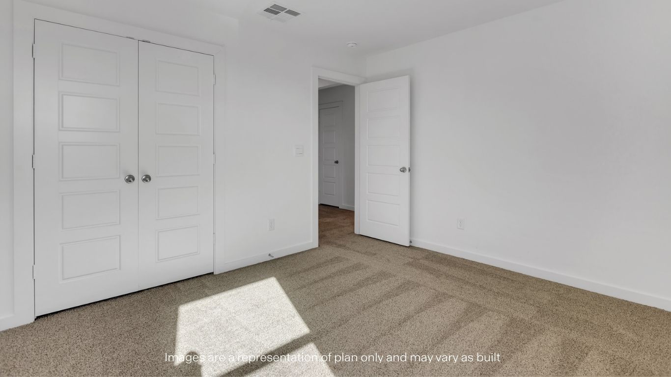 Guest bedroom 3 with plush carpet floors and spacious closet