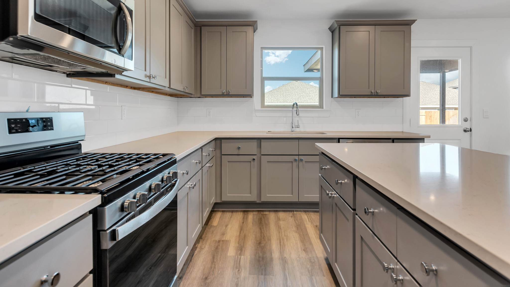 Modern kitchen with stainless steel appliances and shaker style cabinets