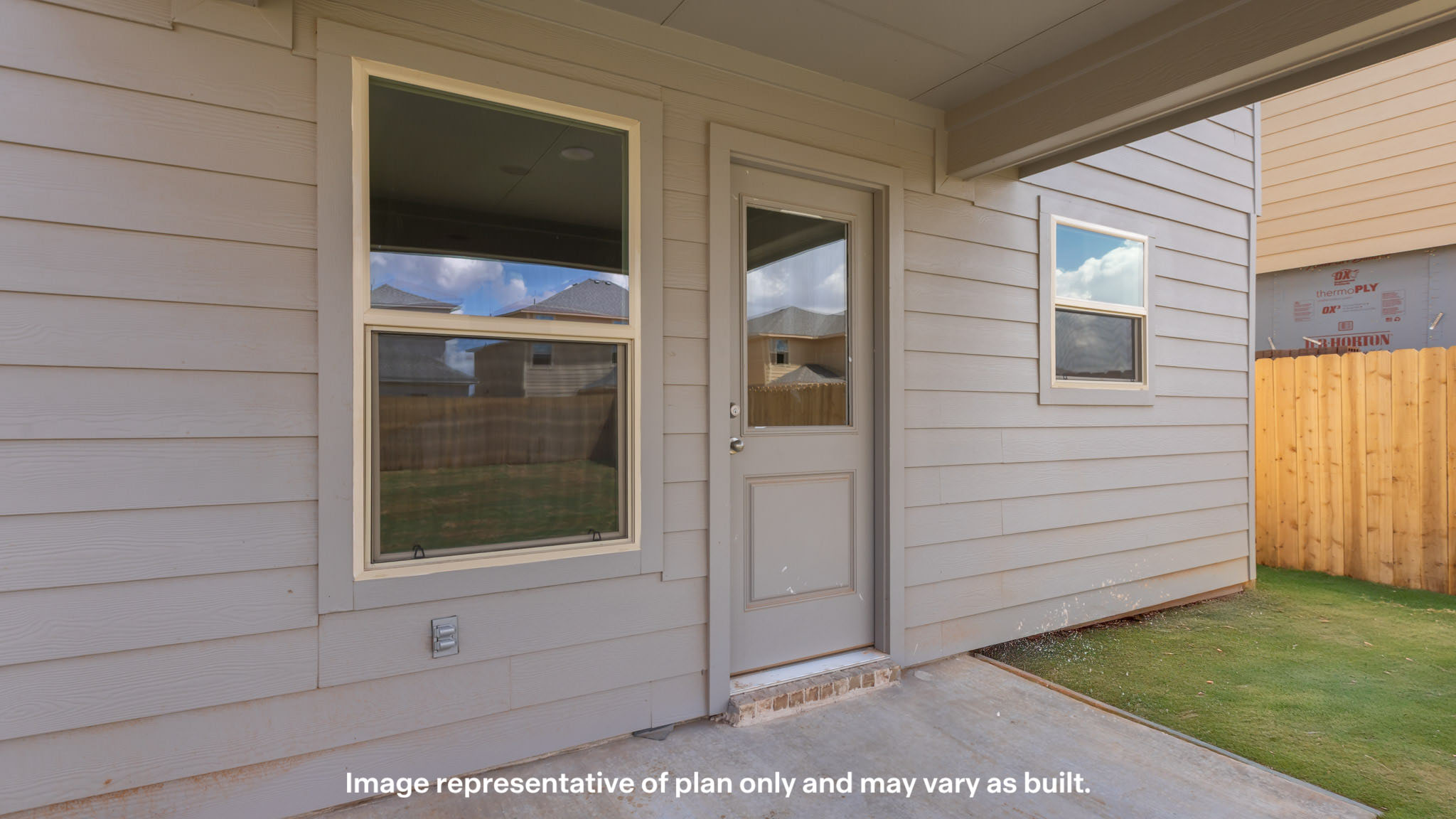 Covered back patio area overlooking private fenced-in backyard