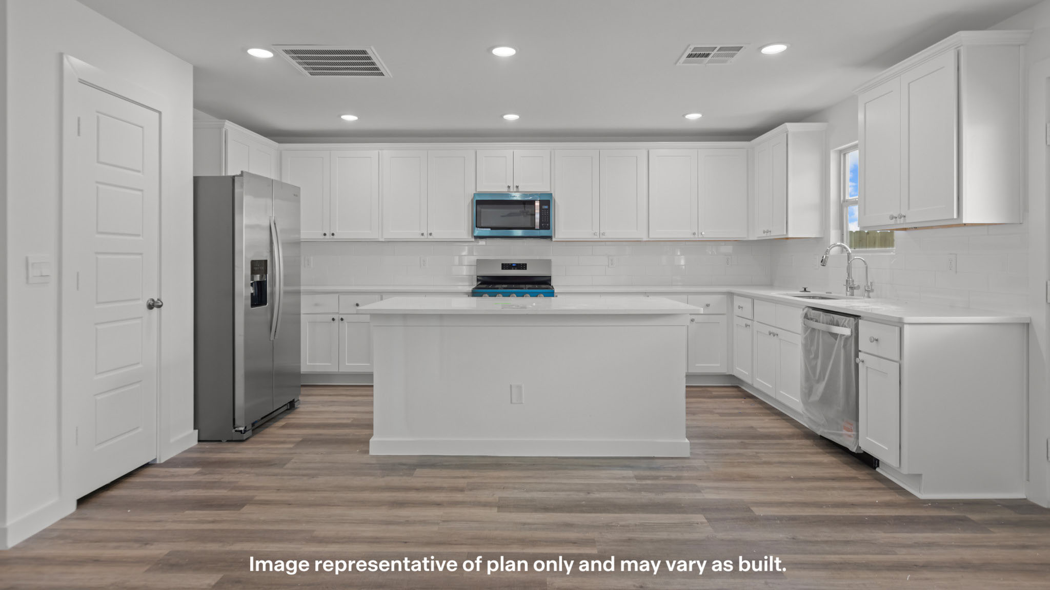 Spacious open concept kitchen with island and counter prep space