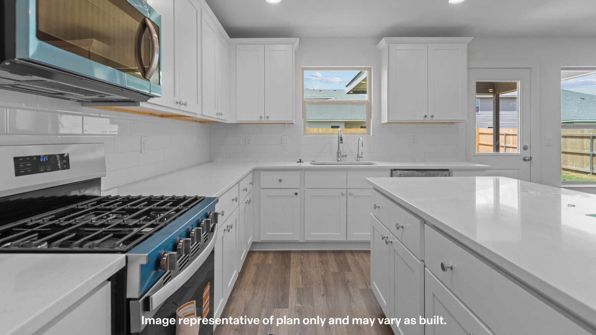 Kitchen with stainless steel appliances, shaker style cabinets, and elevated finishes