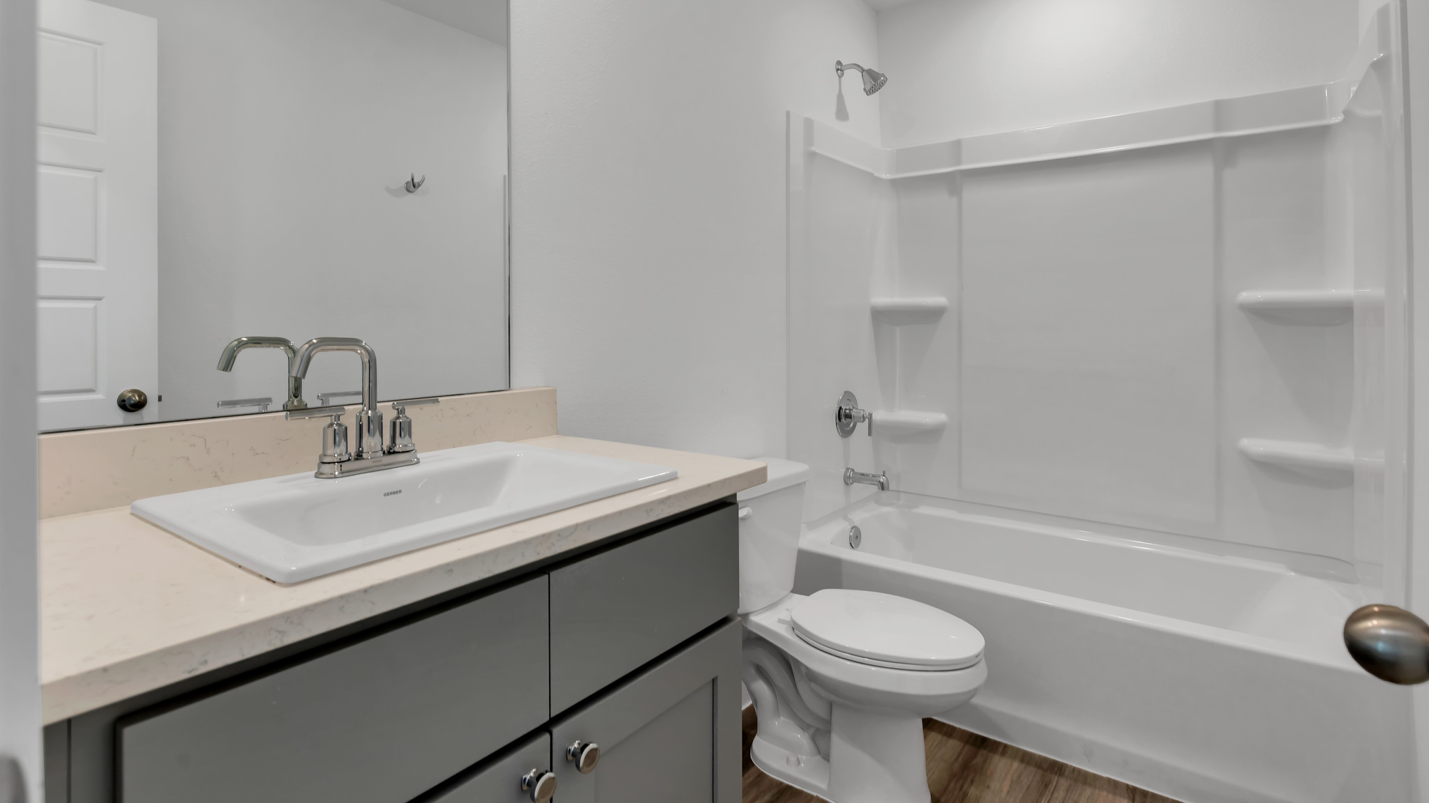 Combination bathtub and shower restroom located between rooms 1 and 2