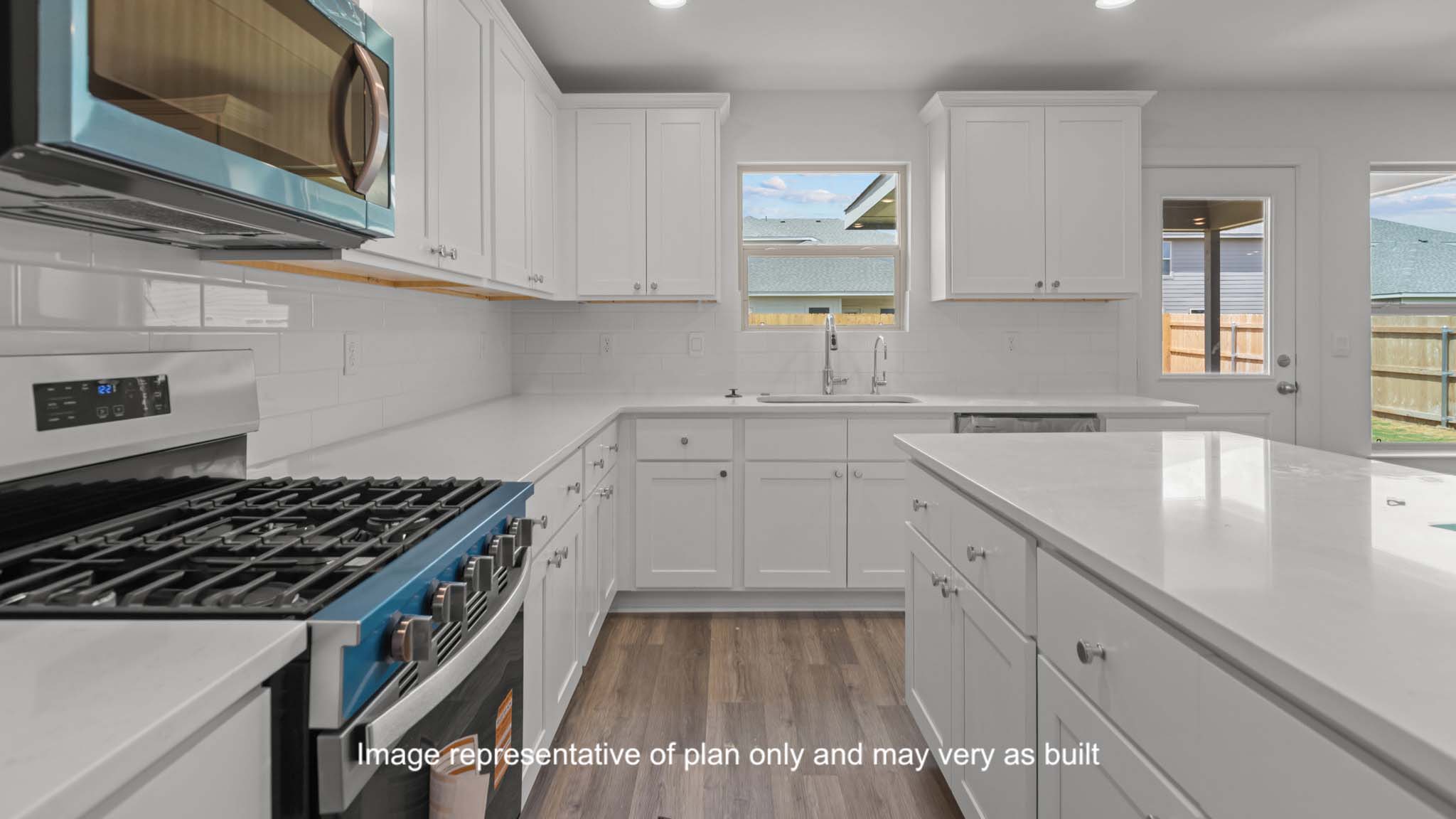 Open concept kitchen with stainless steel appliances, shaker style cabinets, and elevated finishes