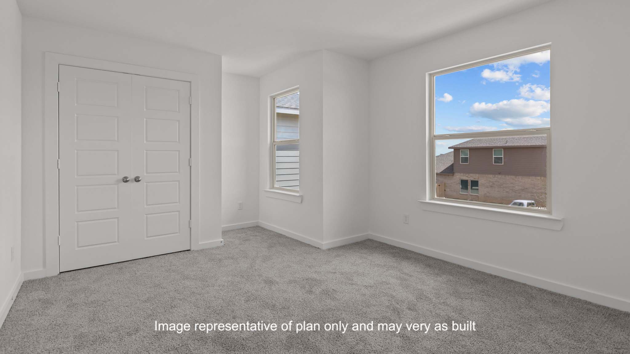 Upstairs Guest bedroom 1 with plush carpet floors and spacious closet
