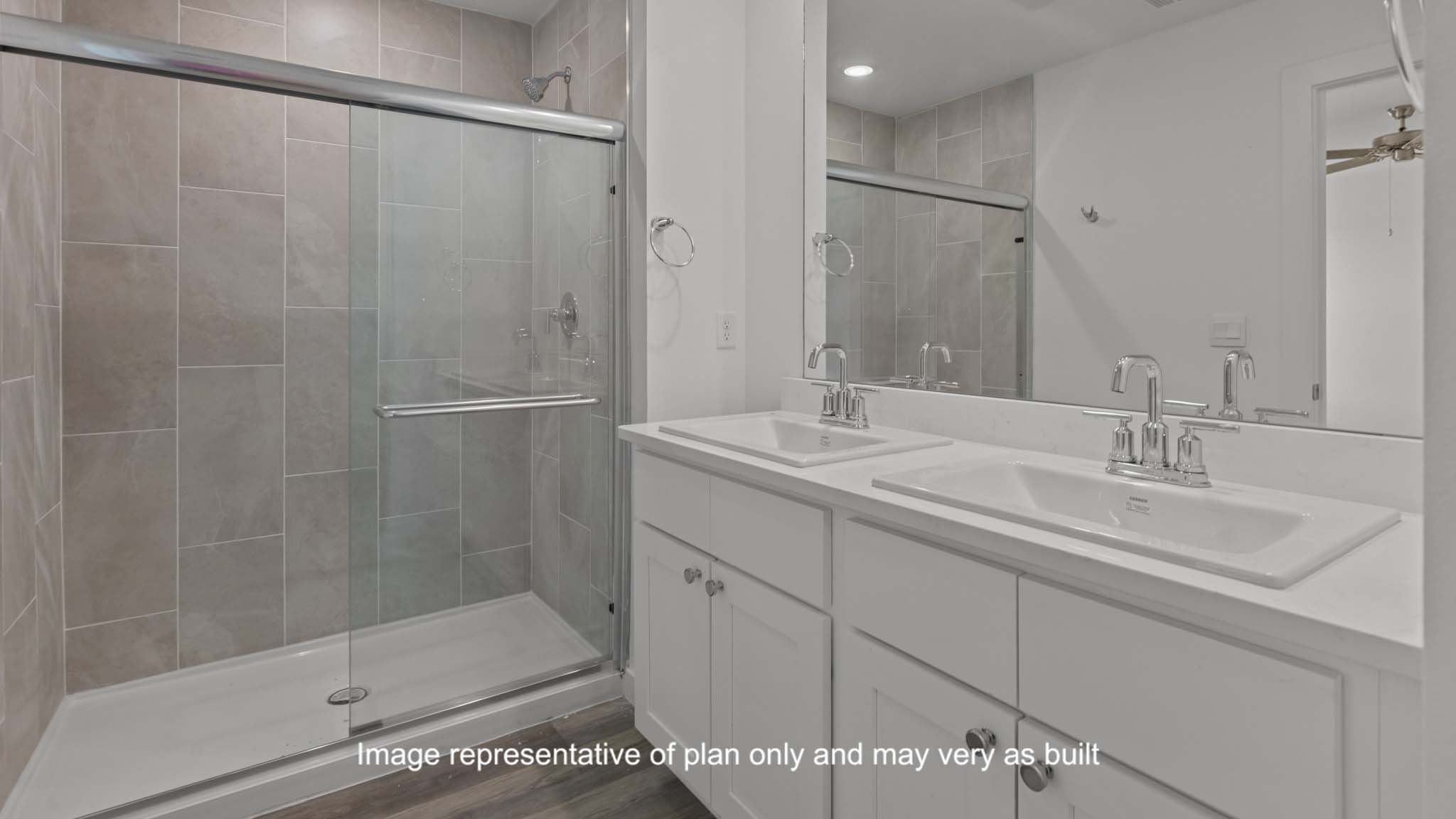 Primary bathroom with built in vanity and luxurious shower