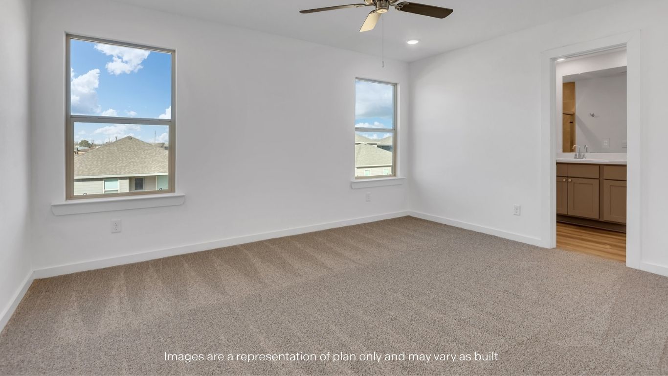 Primary bedroom with plush carpet floors and light allowing double windows