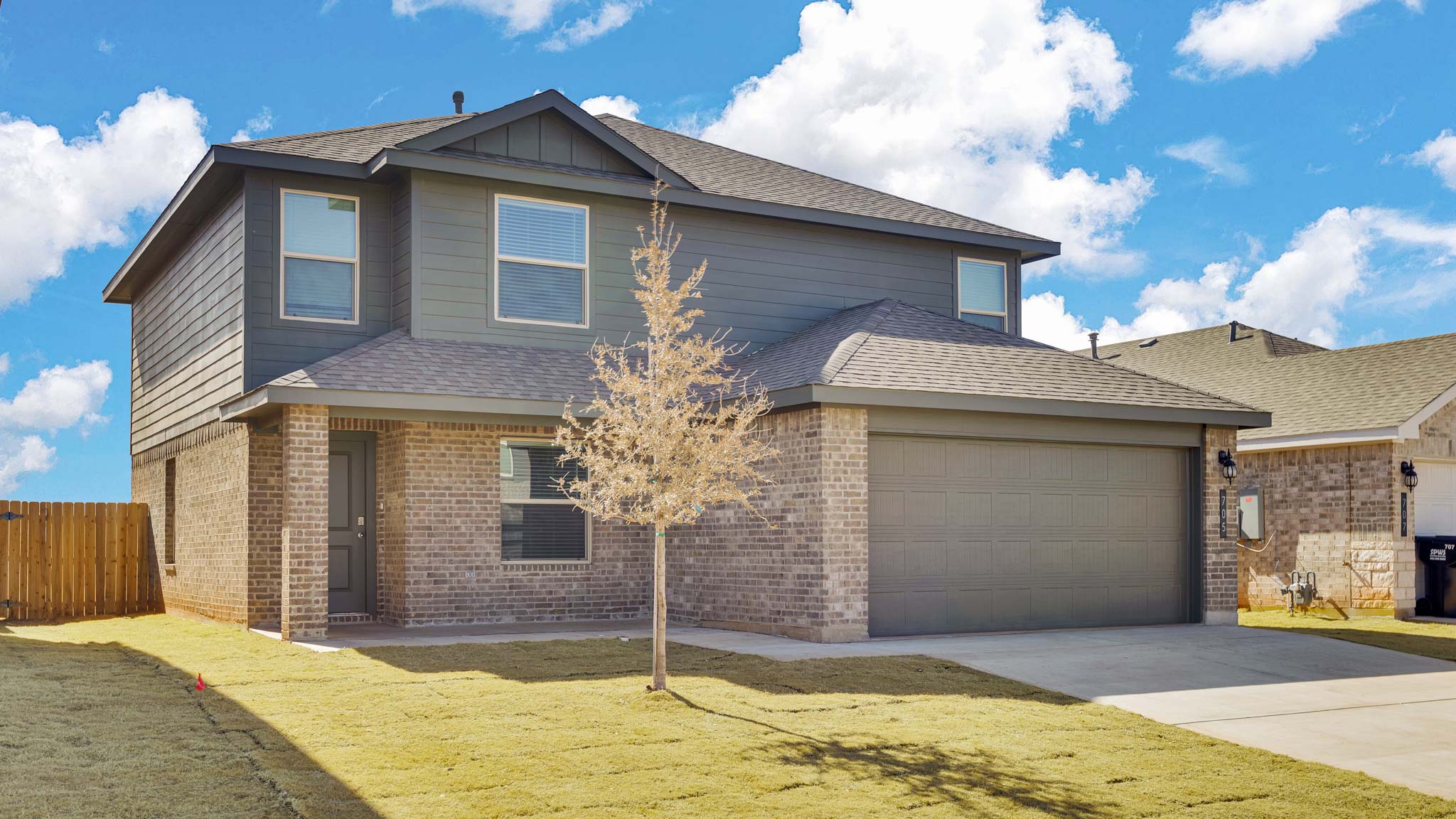 Side view of two story timeless brick home
