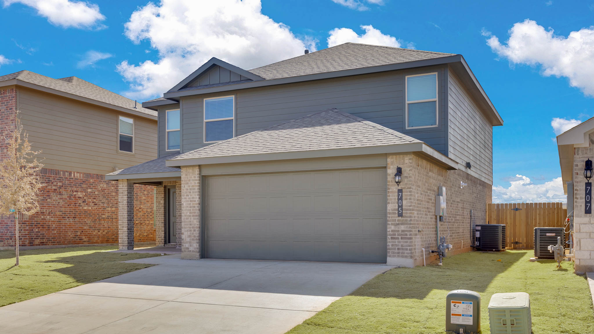 Side view of two story timeless brick home
