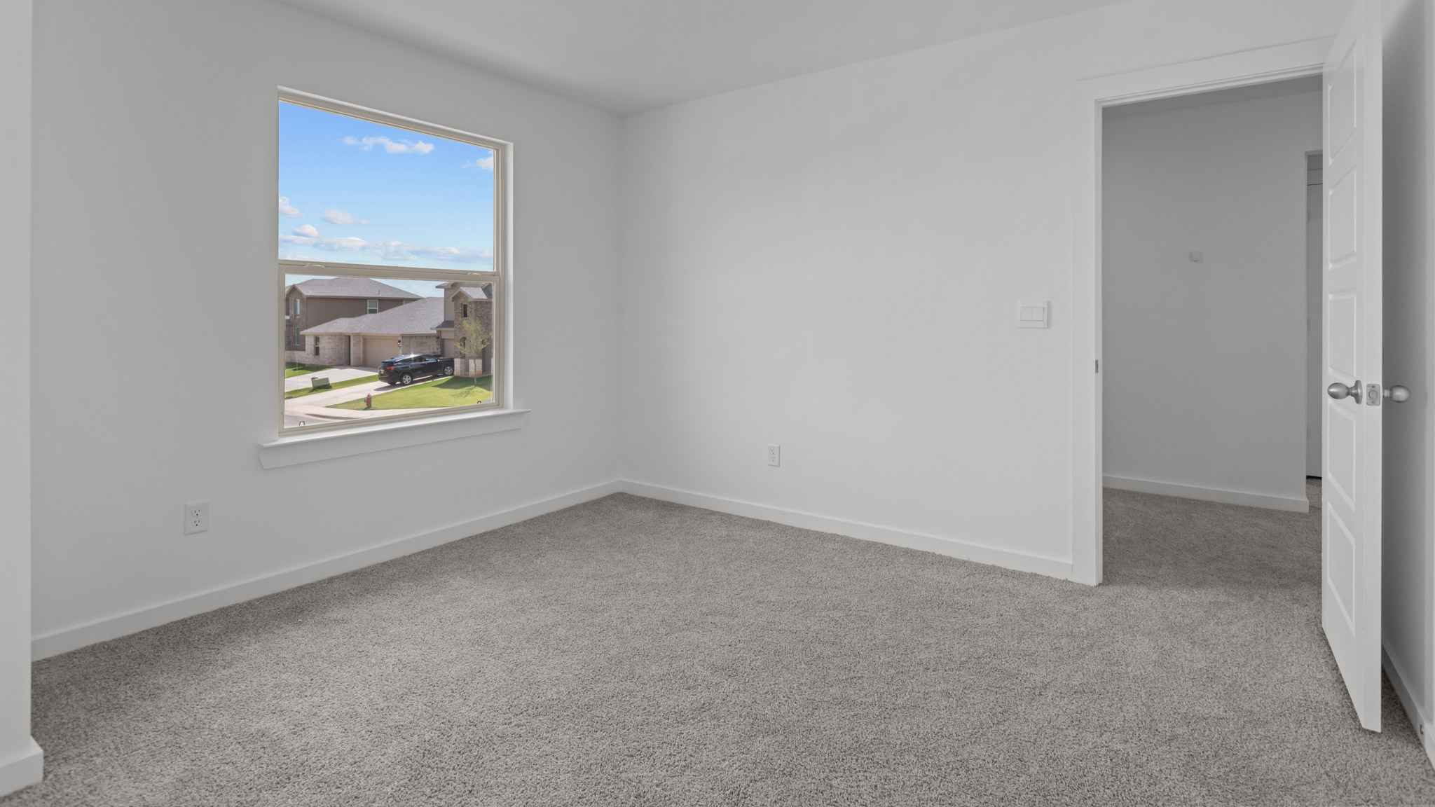 Upstairs guest bedroom 2 with plush carpet floors