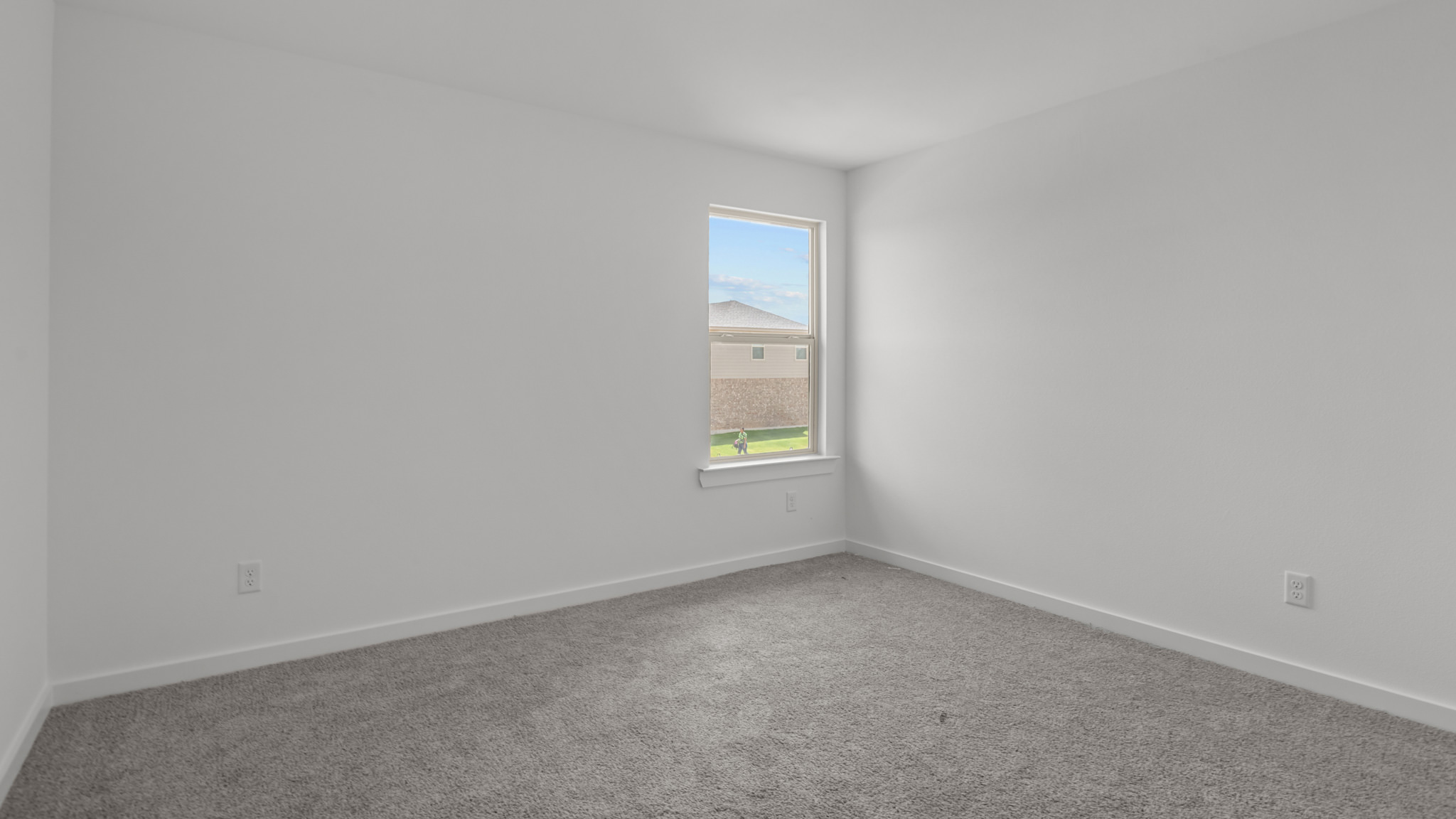 Upstairs guest bedroom 3 with plush carpeted floors and ample natural light