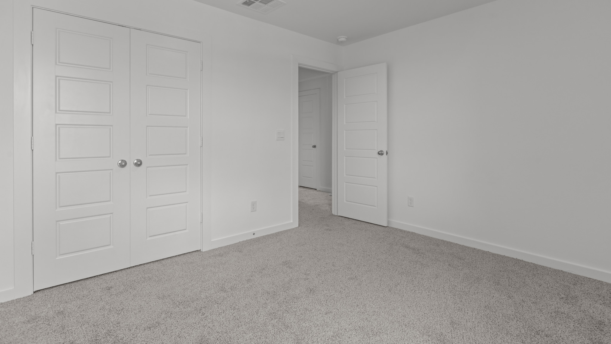 Upstairs guest bedroom 3 with plush carpeted floors and ample natural light