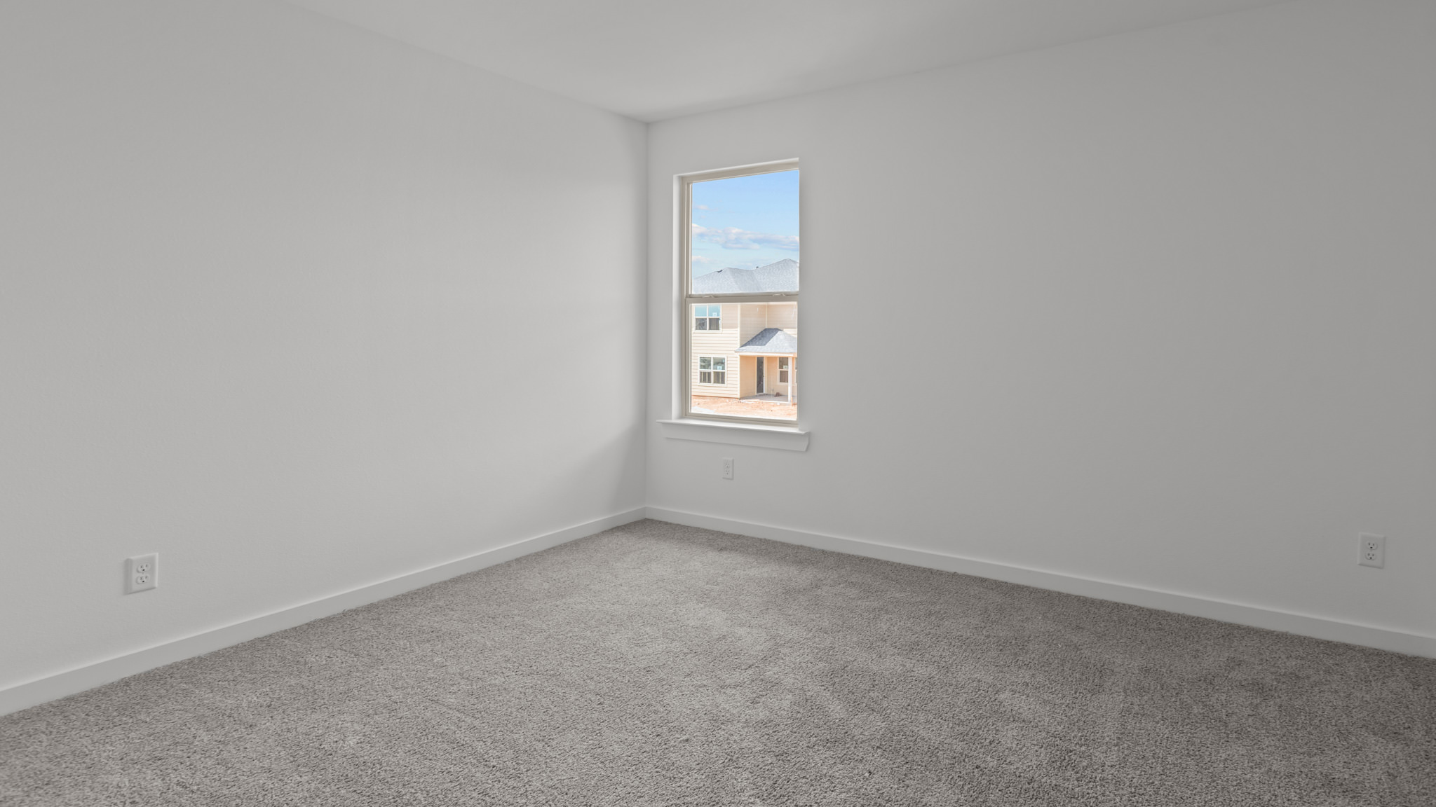 Upstairs guest bedroom 4 with plush carpet floors and side window
