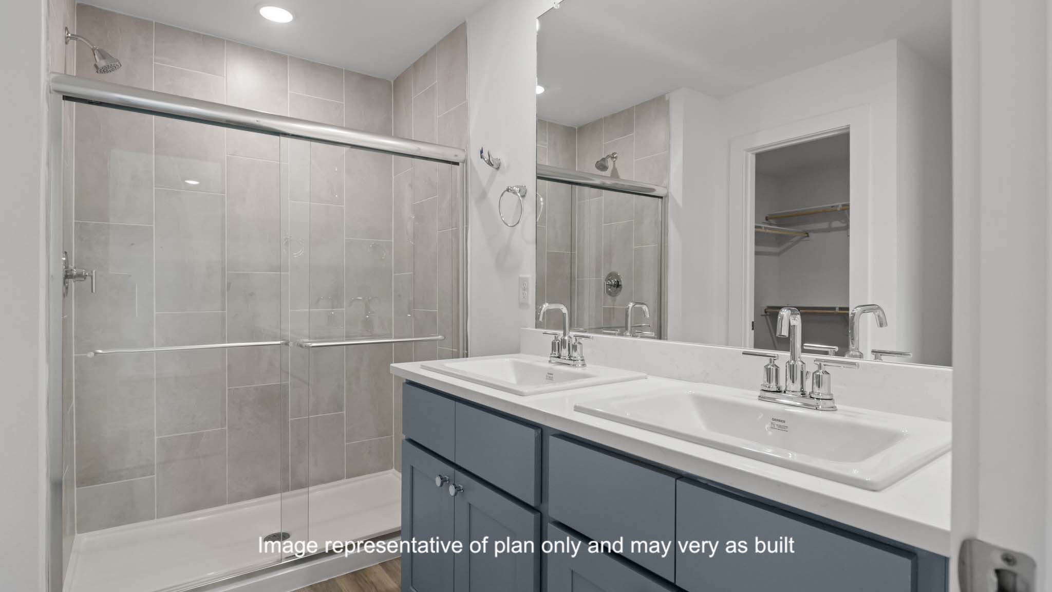 Private attached primary bathroom with built in vanity and luxurious shower
