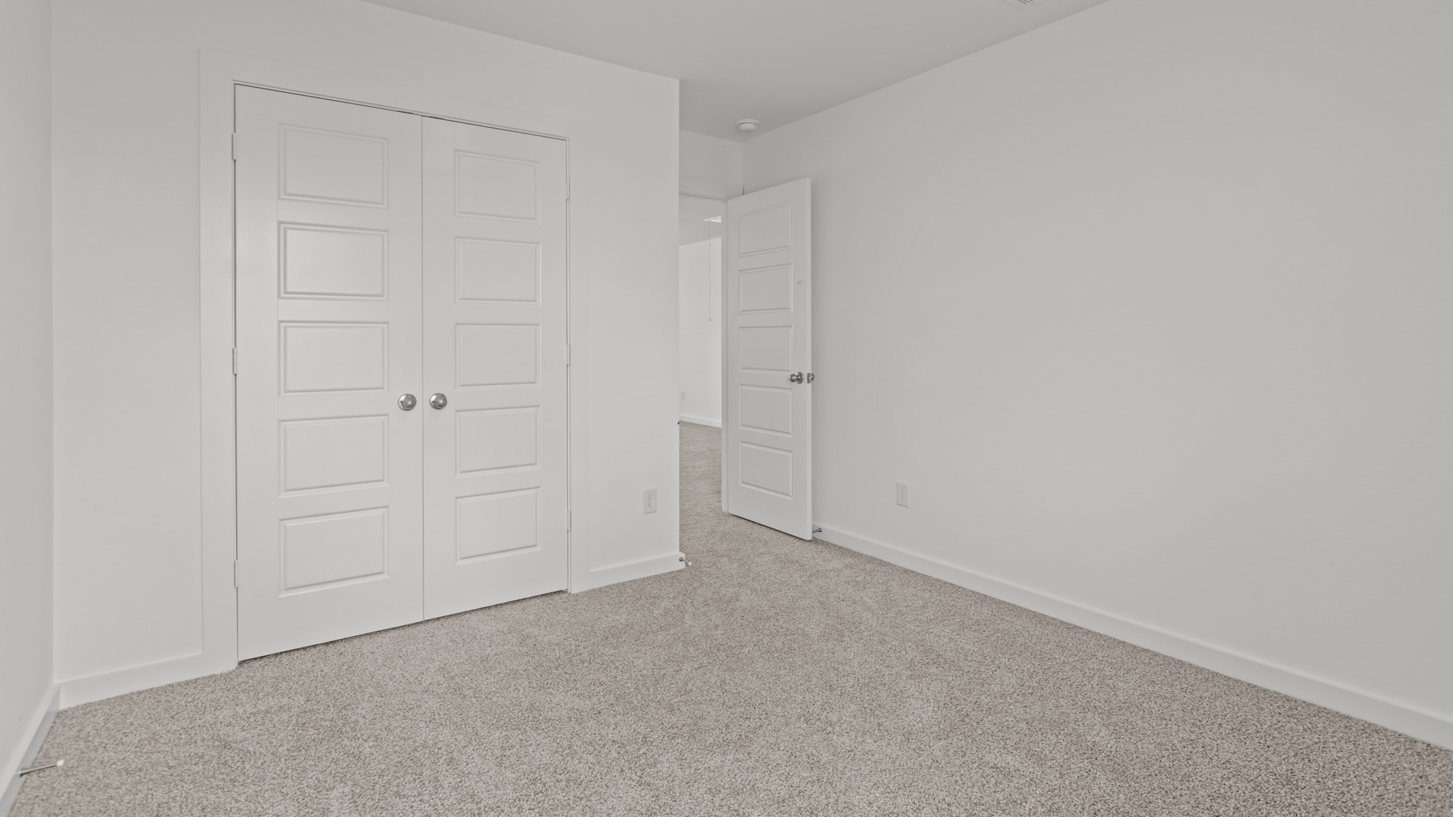 Upstairs guest bedroom 2 with plush carpet floors