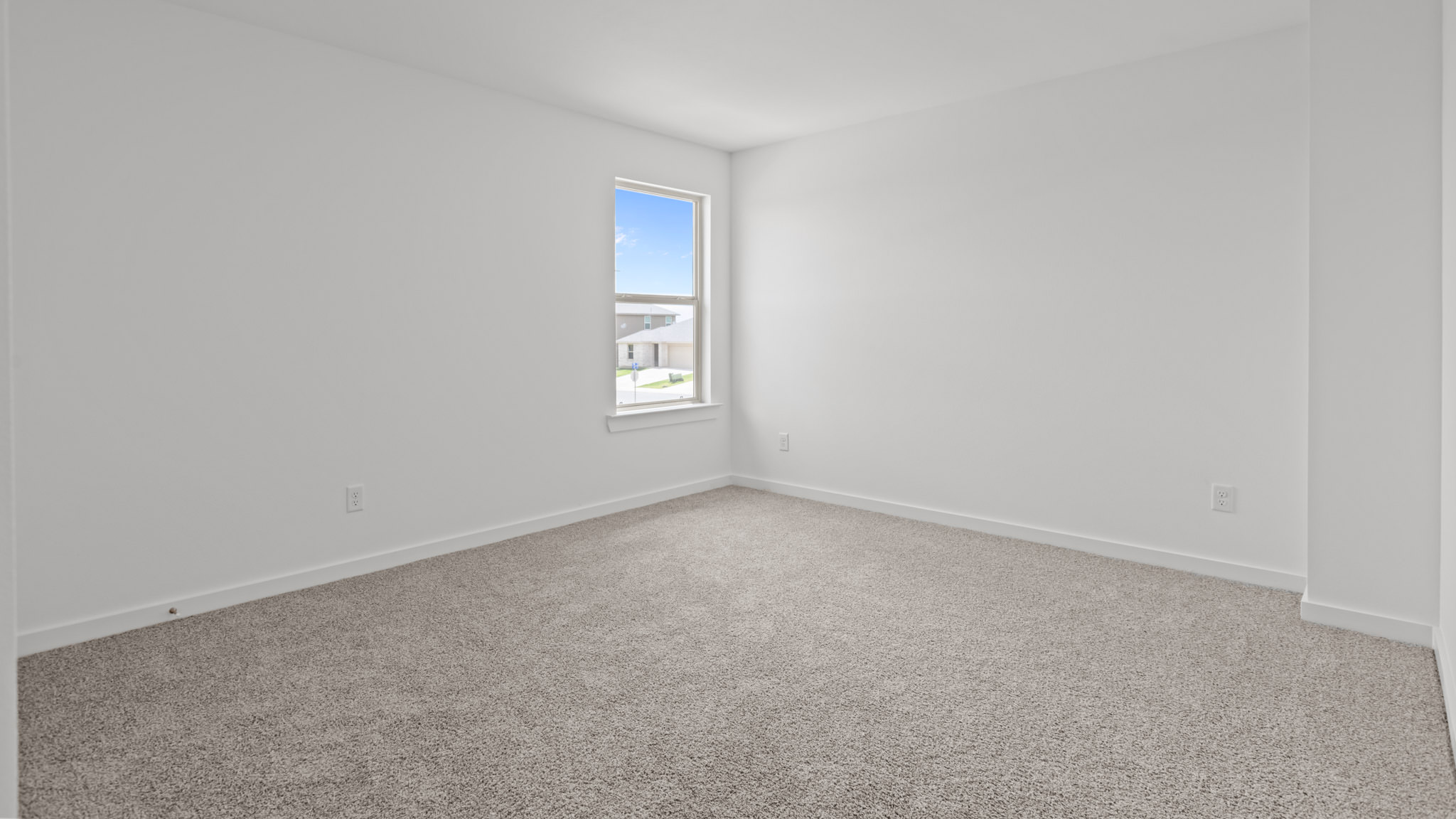 Upstairs guest bedroom 3 with plush carpeted floors and ample natural light