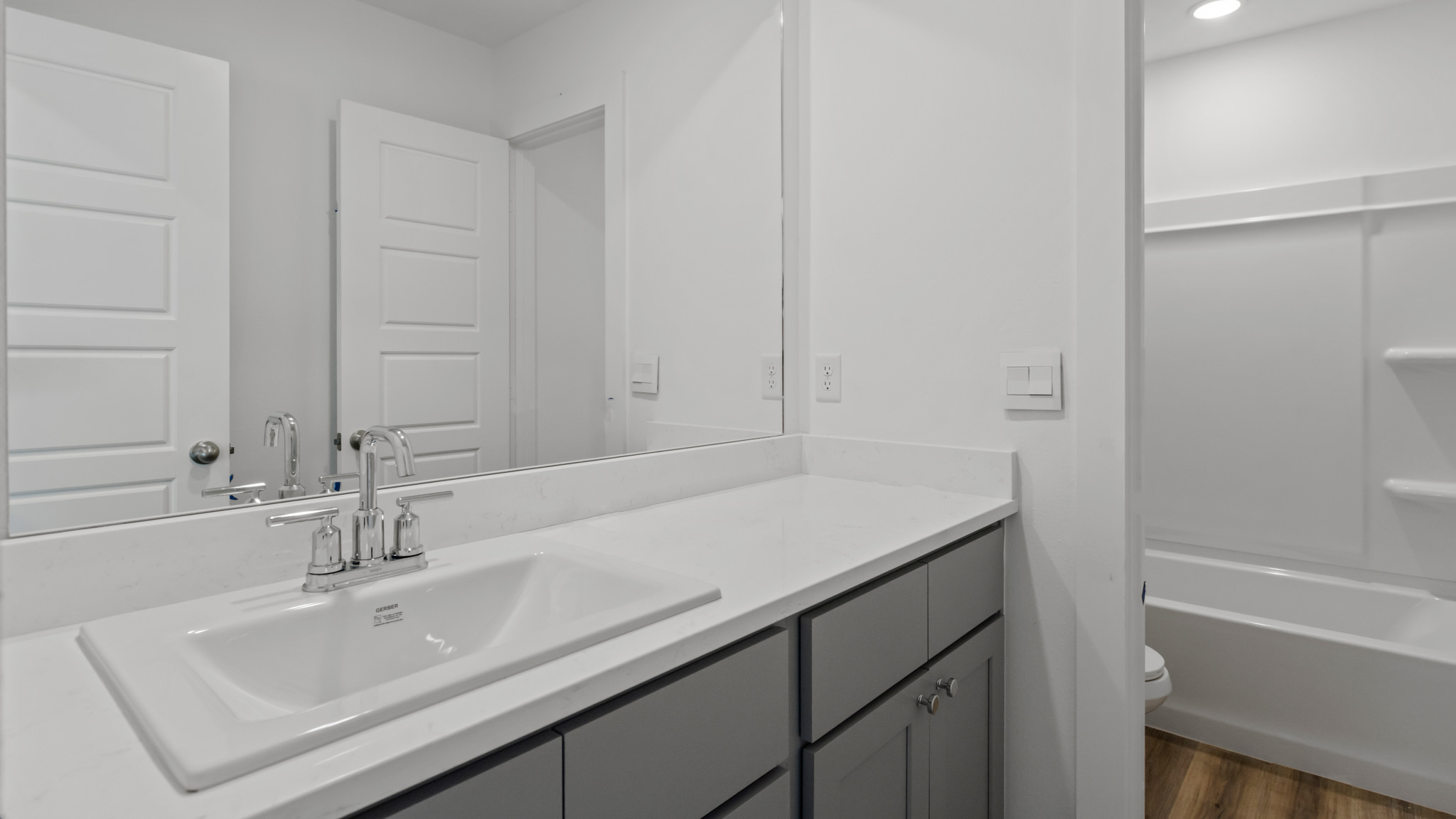 Upstairs guest bathroom with combination shower and bathtub