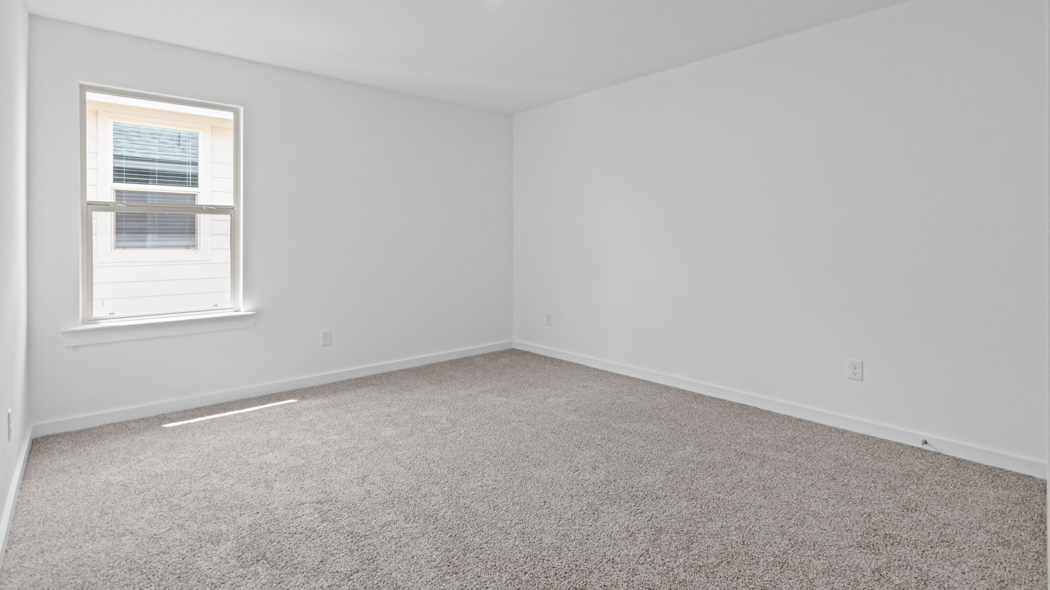 Upstairs guest bedroom 4 with plush carpet floors and side window
