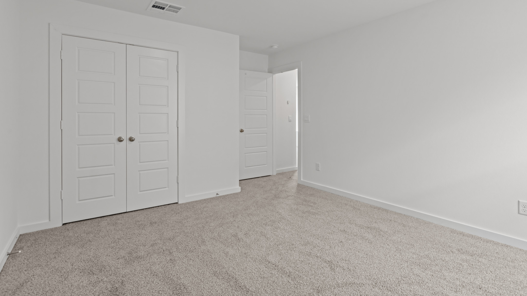Upstairs guest bedroom 4 with plush carpet floors and side window