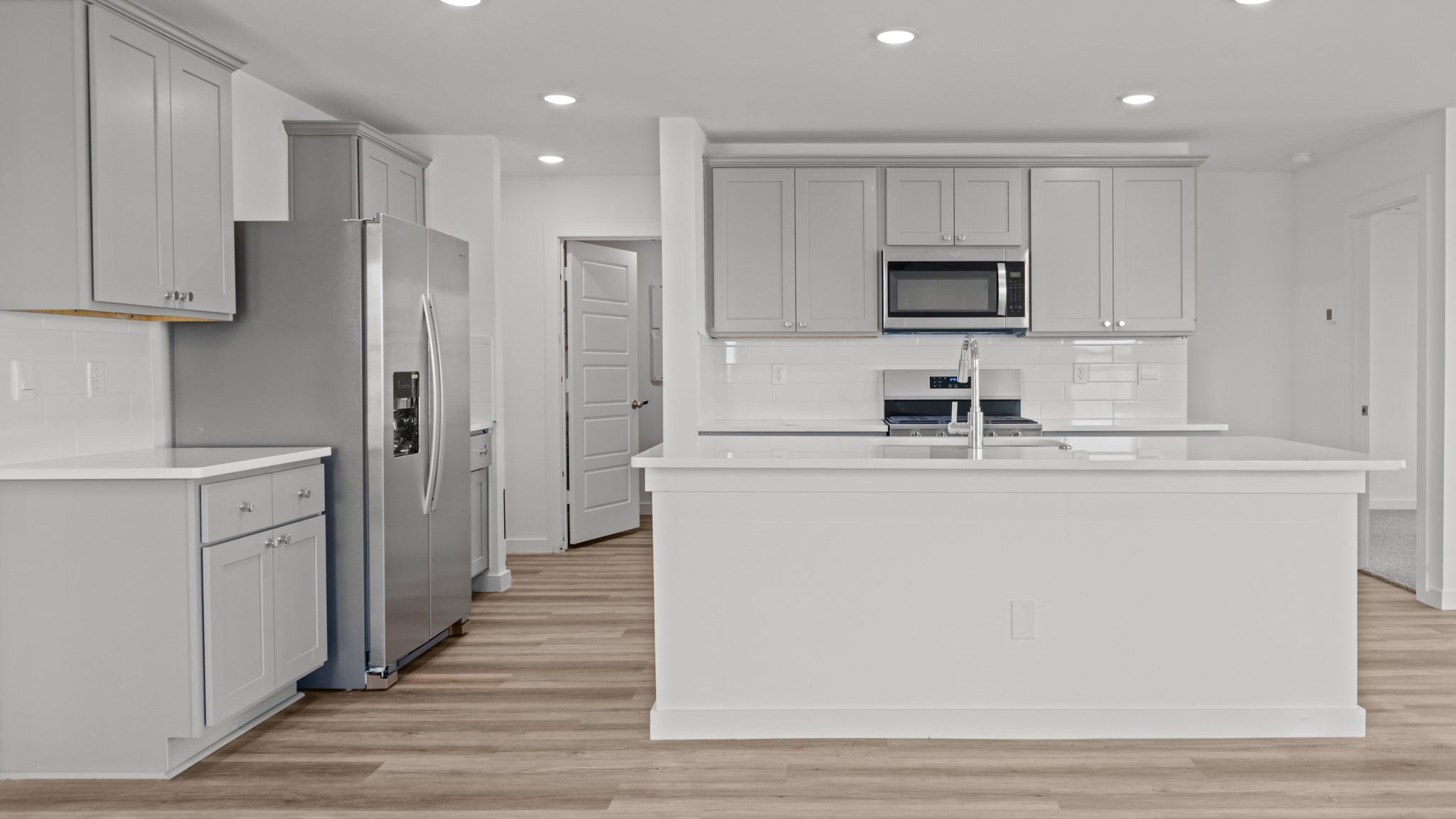 Spacious open concept kitchen with island and counter prep space