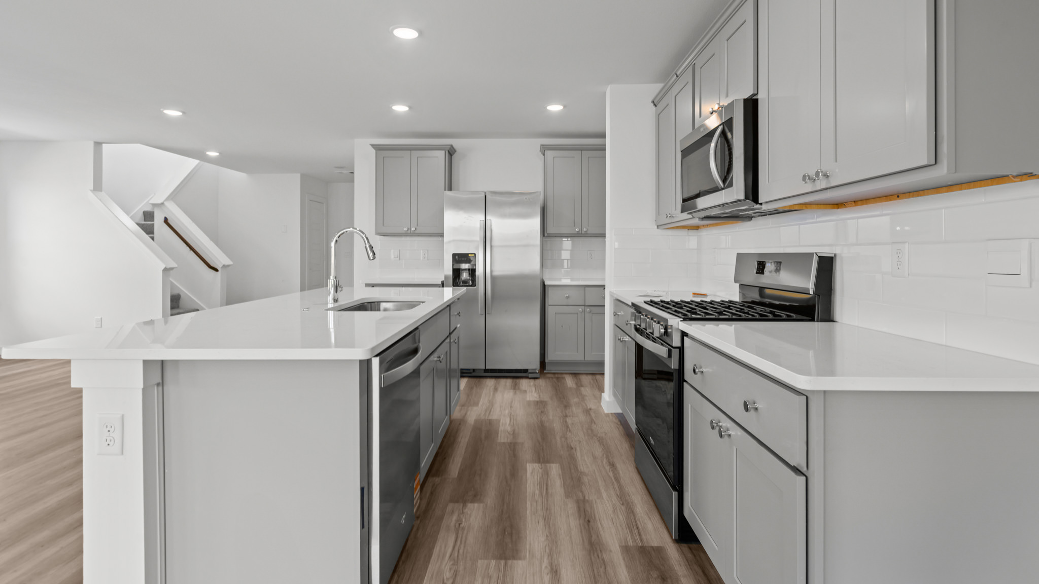 Kitchen with stainless steel appliances, shaker style cabinets, and elevated finishes
