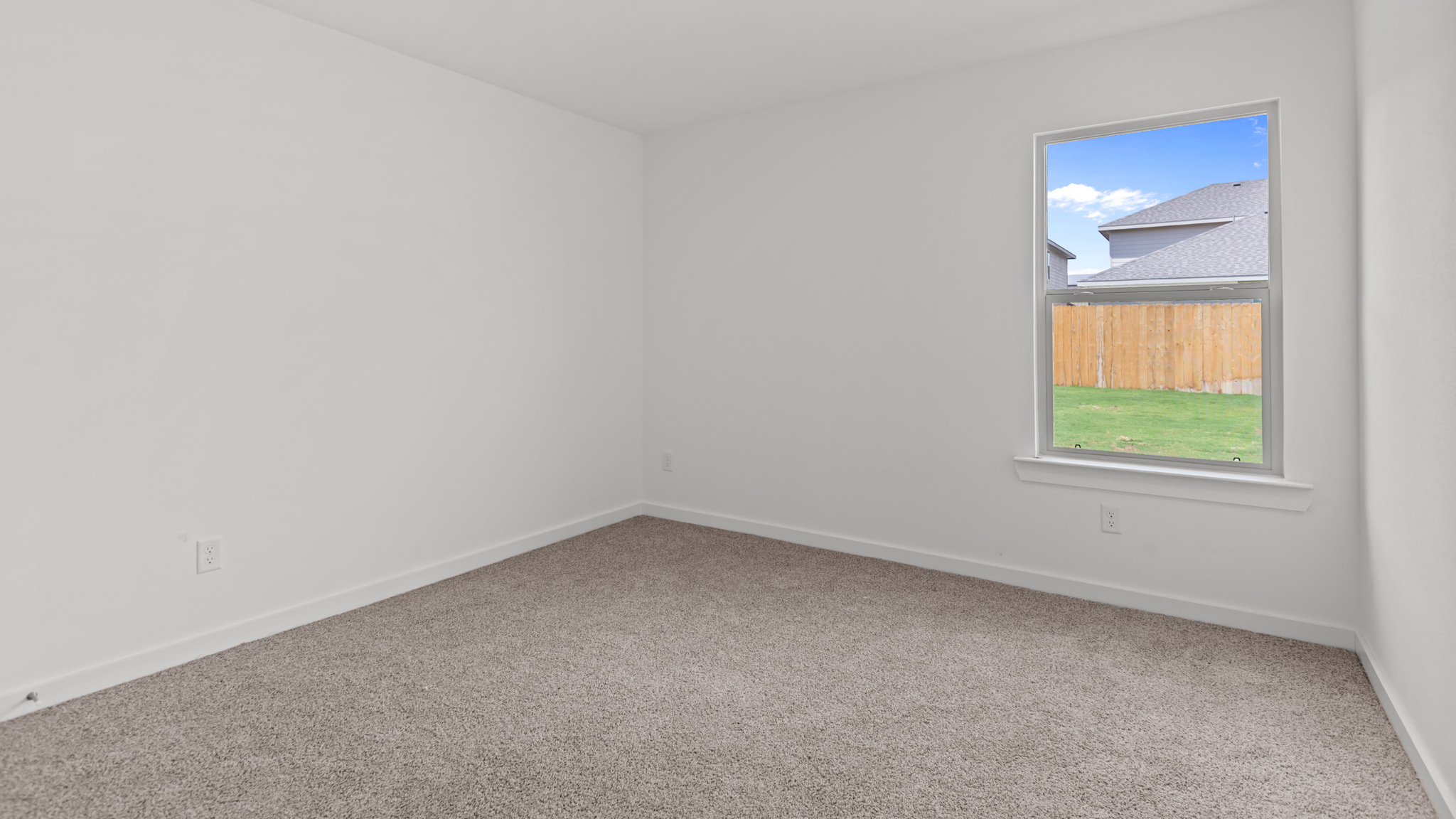 Downstairs guest bedroom with plush carpet floors
