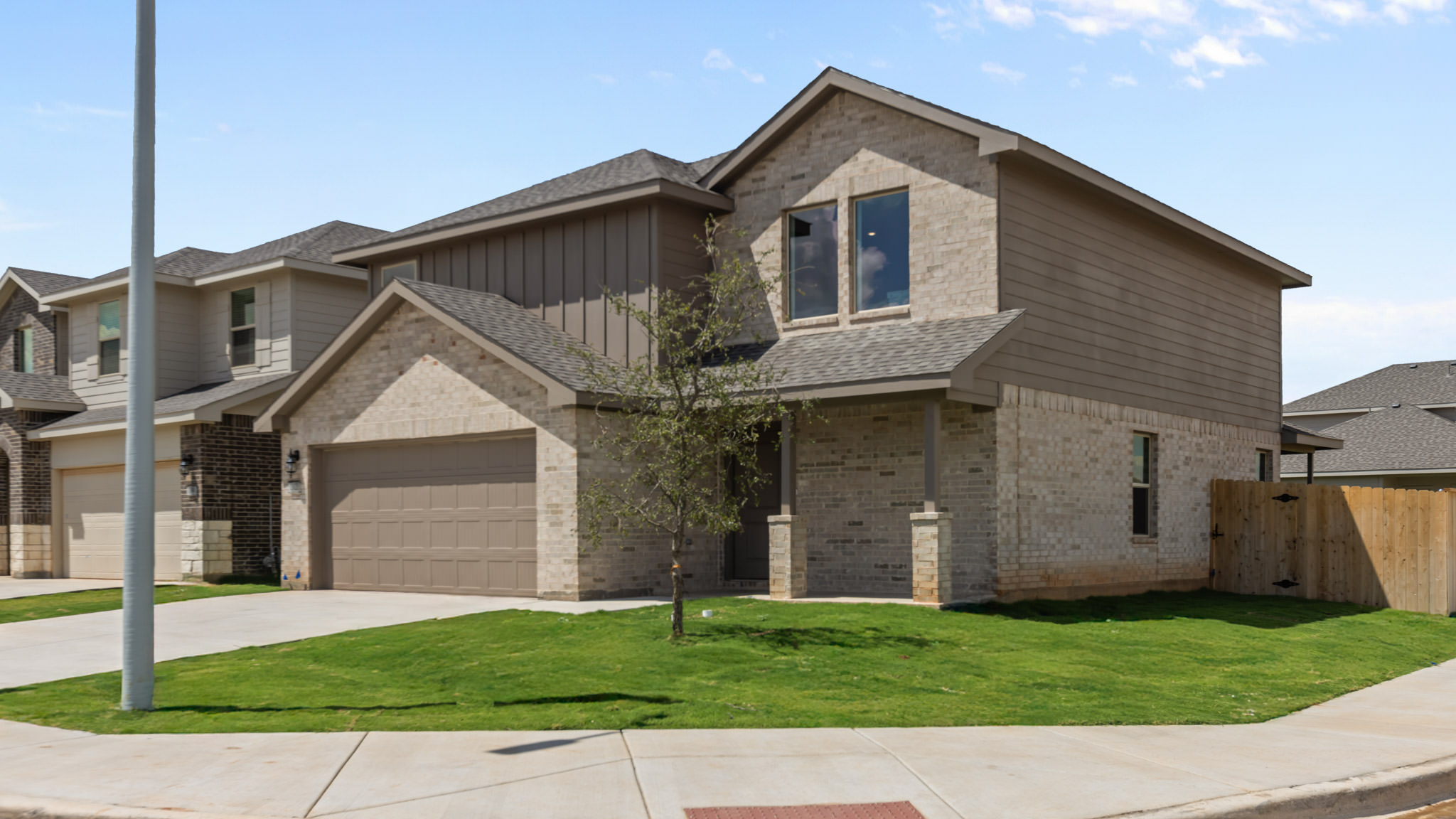 Side view of two story timeless brick home