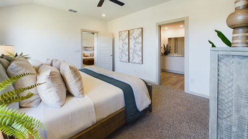 primary bedroom with plush carpet and attached bathroom