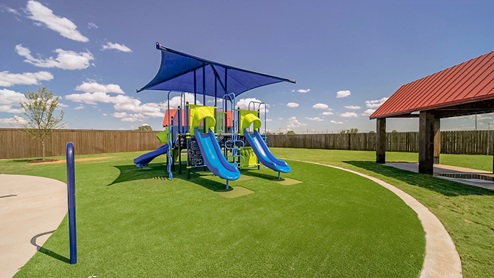Overlook West playground with slides and fun playset, soft turf and green grass areas, and covered sitting areas