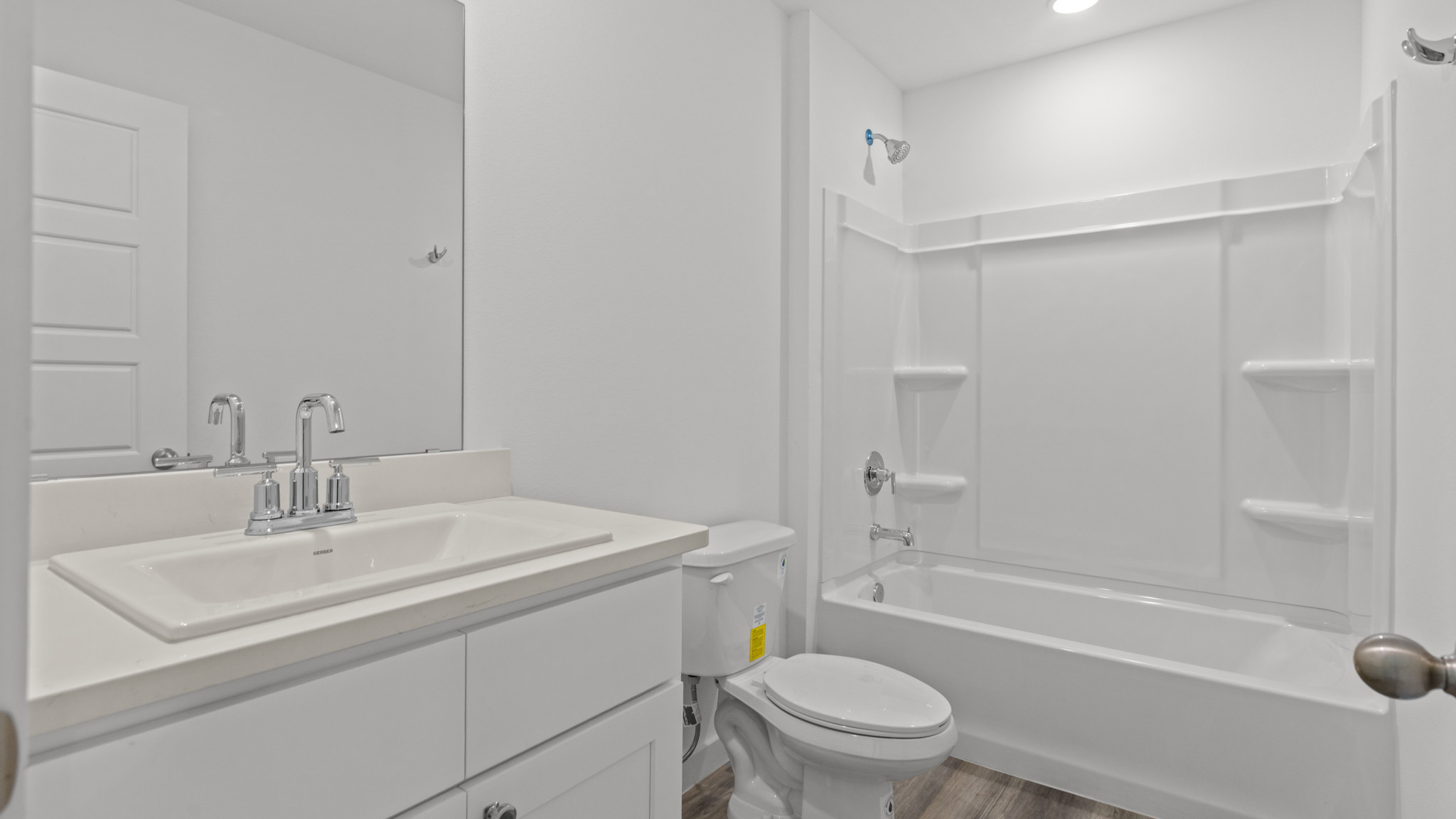guest bathroom with single sink, vanity and bathtub shower combo