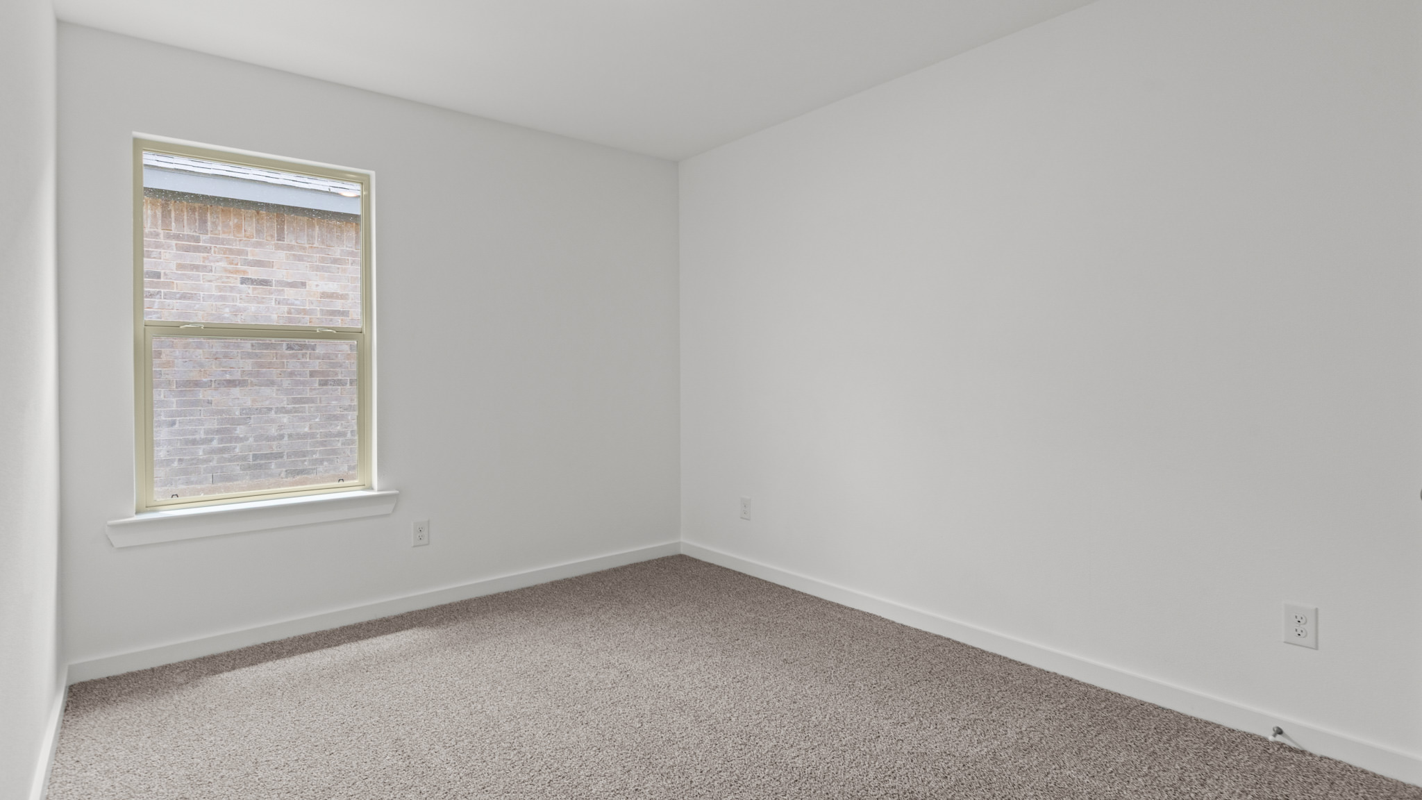 guest bedroom with plush carpet and spacious closet