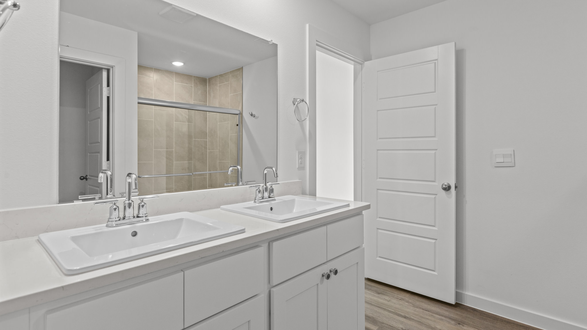primary bathroom with quartz counters and dual vanity