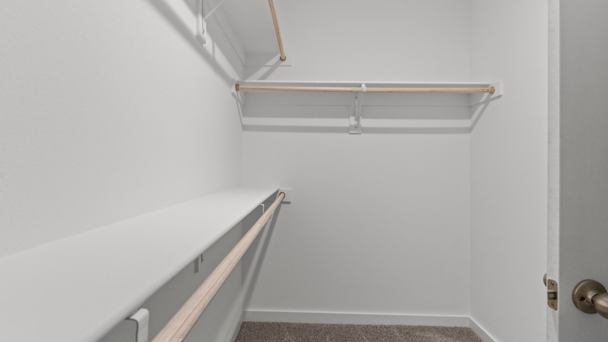 large walk in closet with wooden shelving