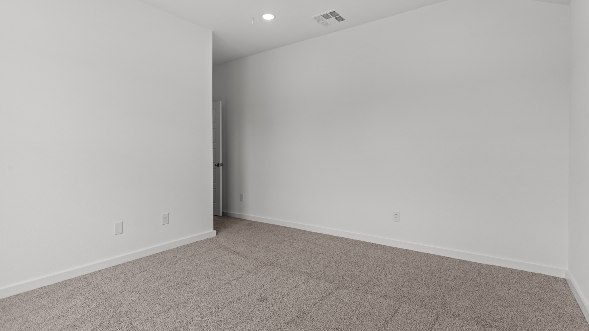 guest bedroom with plush carpet and spacious closet