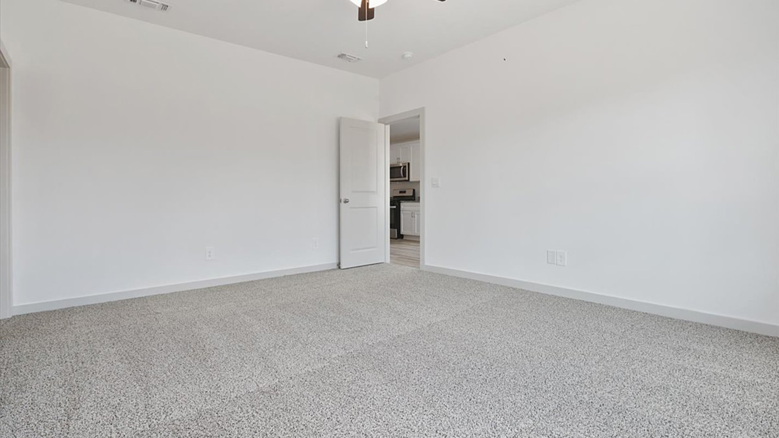 Primary bedroom with private attached bathroom and walk-in closet