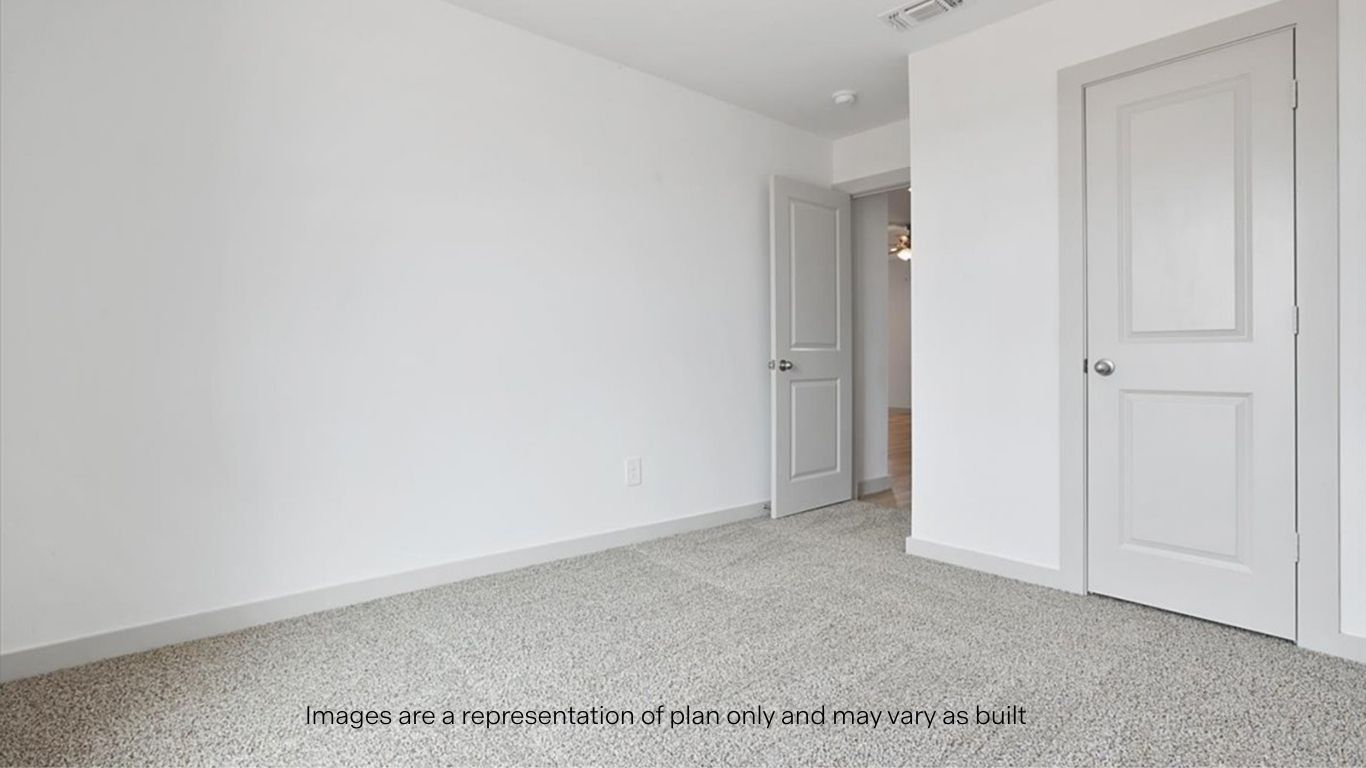 Guest bedroom with plush carpet floors and spacious closet