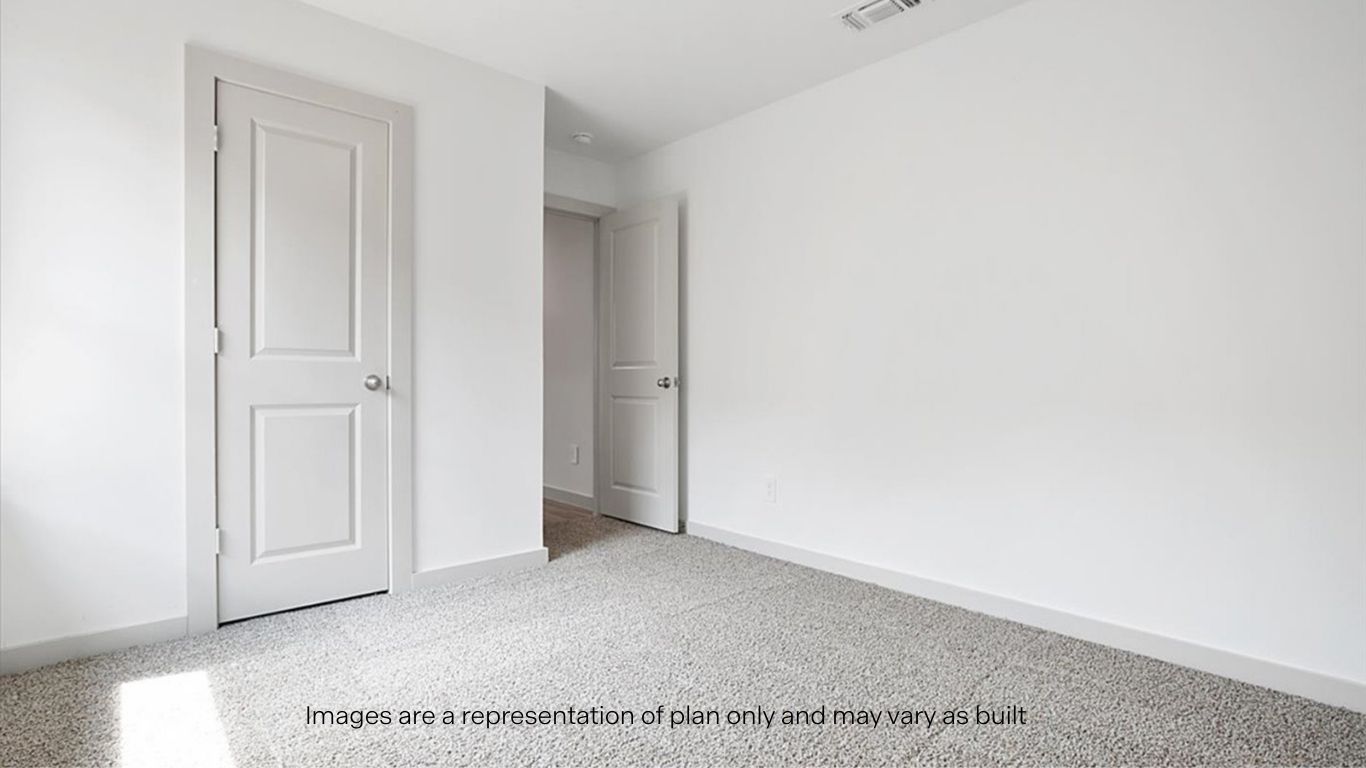 Guest bedroom with plush carpet floors and spacious closet