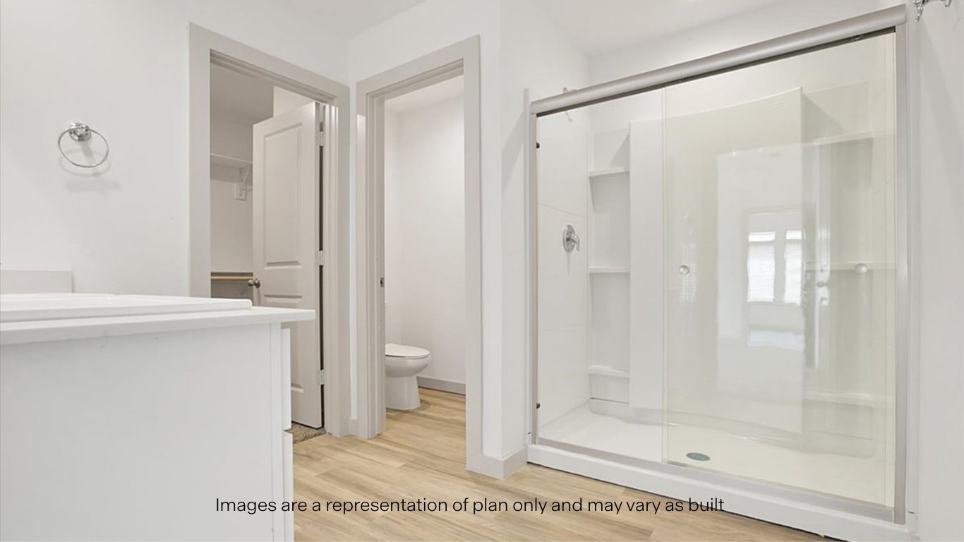 Private attached primary bathroom with built in vanity and luxurious shower