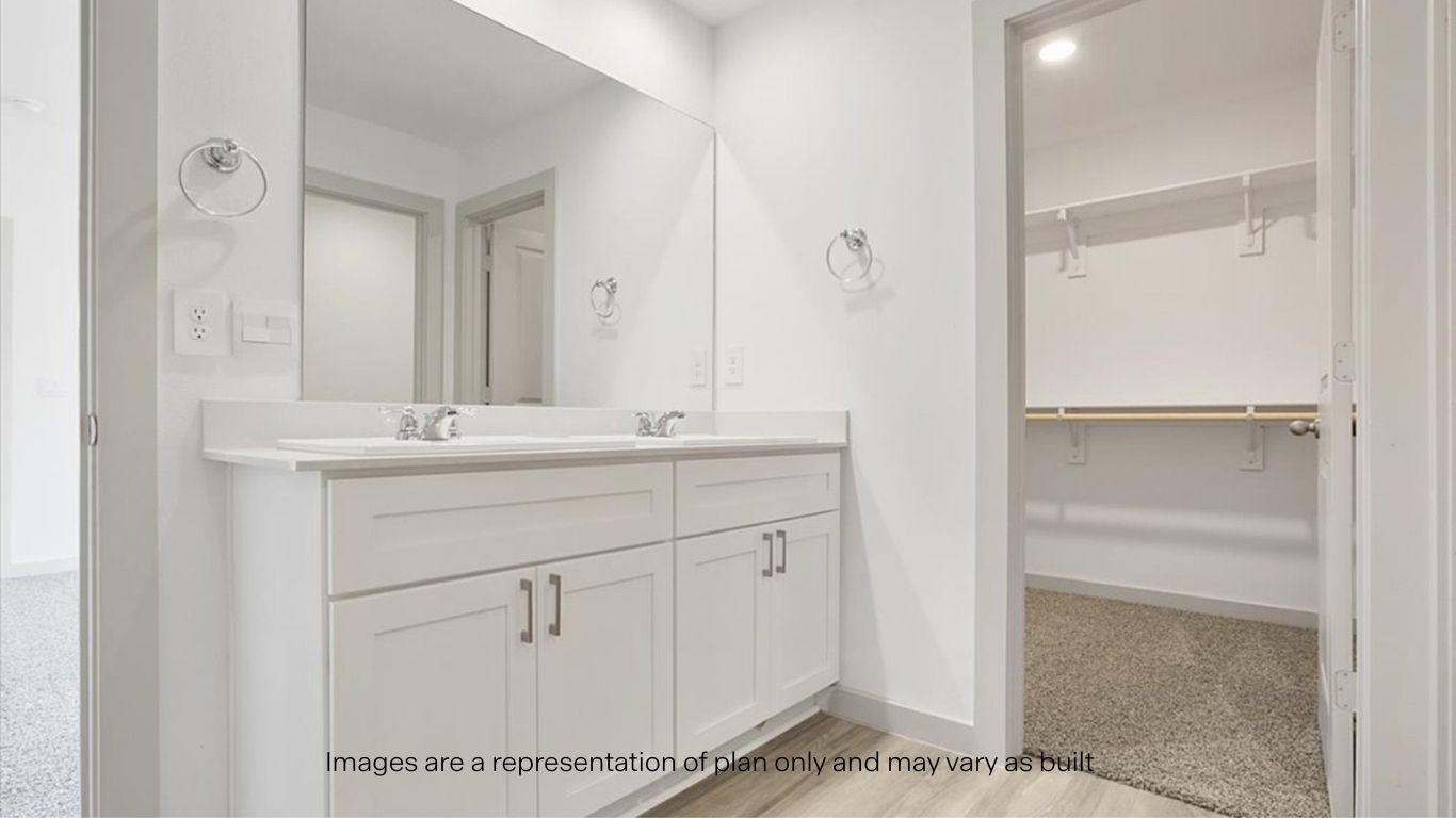 Private attached primary bathroom with built in vanity and luxurious shower