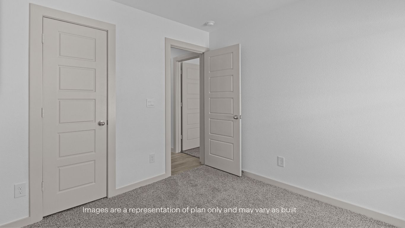 Guest bedroom with plush carpet floors and spacious closet
