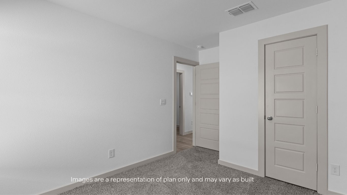 Guest bedroom with plush carpet floors and spacious closet