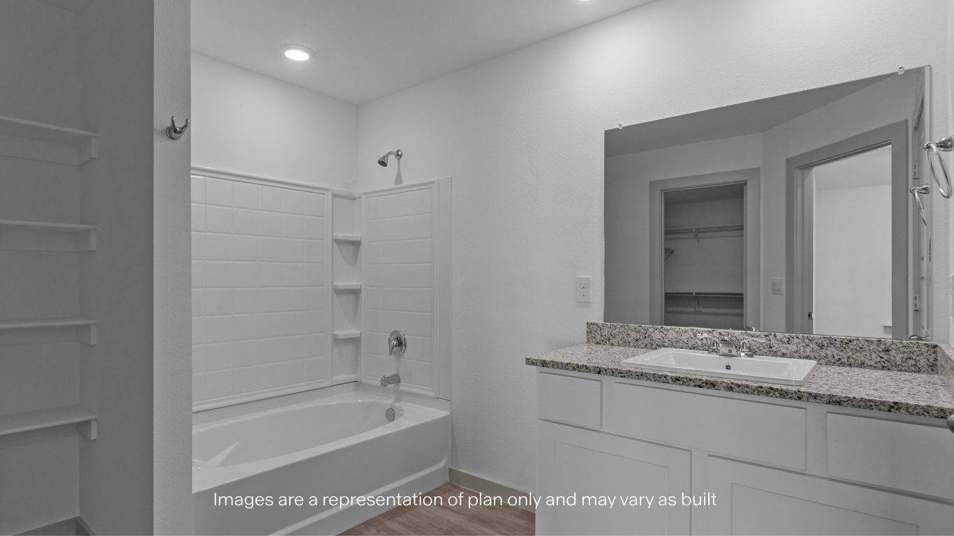 Private attached primary bathroom with built in vanity and luxurious shower