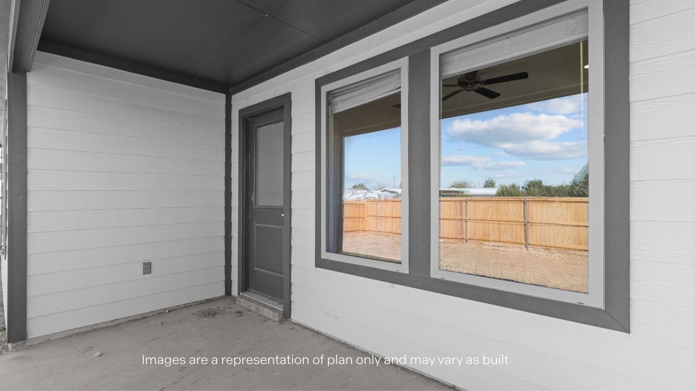 Covered back patio area overlooking spacious backyard